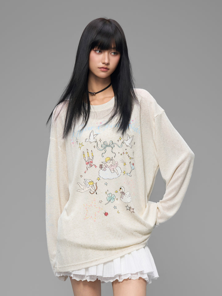 Woman wearing a cream-colored sweater with cartoon designs on a gray background